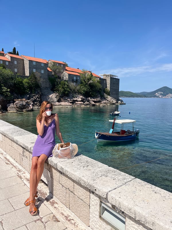 Woman enjoys sunny morning at Sveti Stefan coastal resort