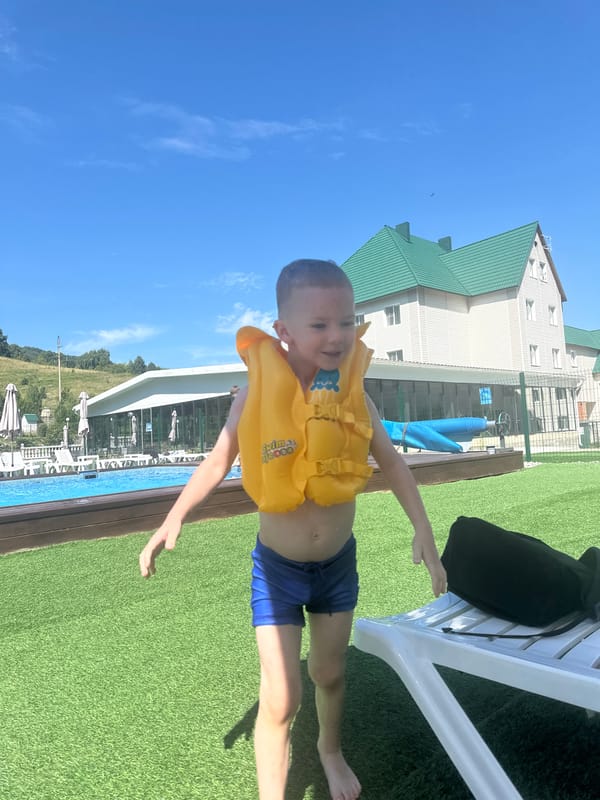 Summer pool day at an Altai resort, kids in life vests