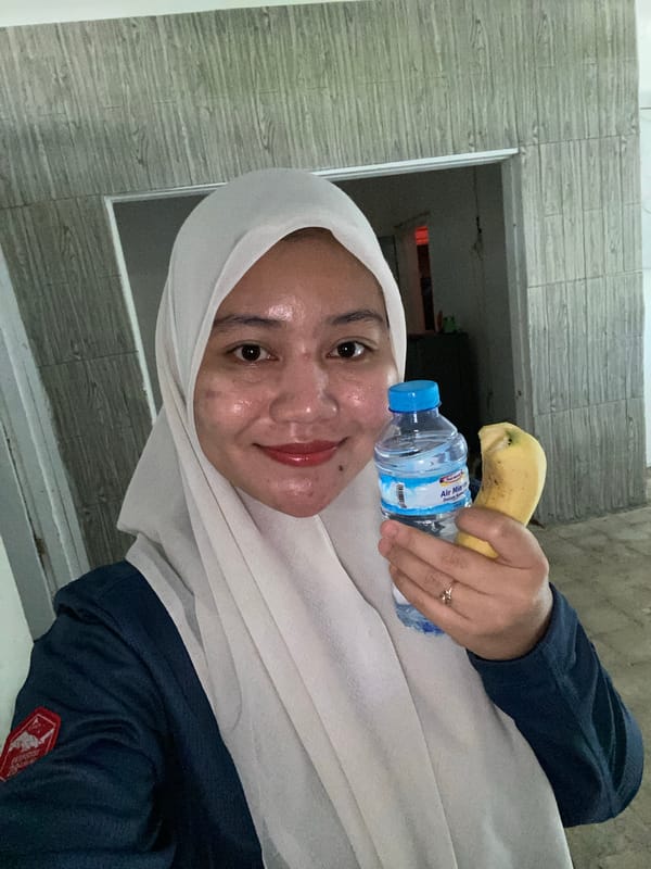 Selfie series on a Banjarbaru road, water bottle and banana in hand