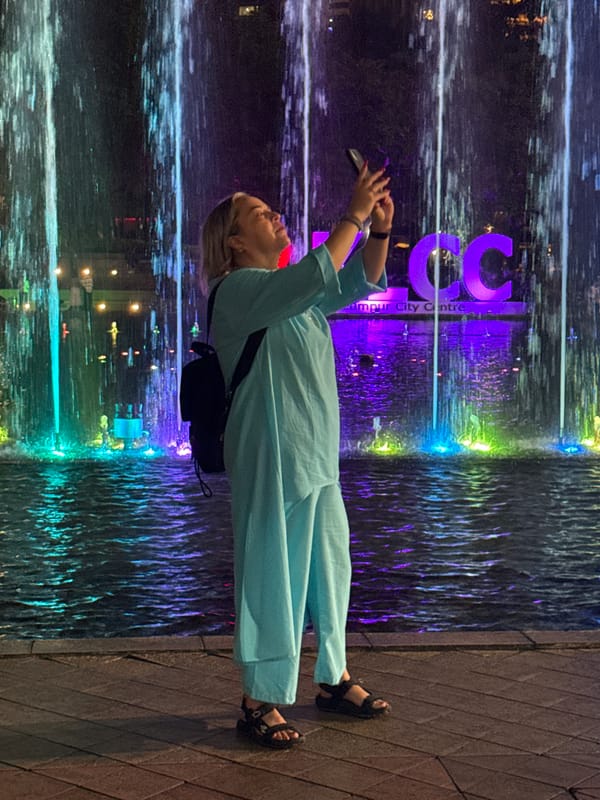Woman photographed by illuminated water feature in Kuala Lumpur
