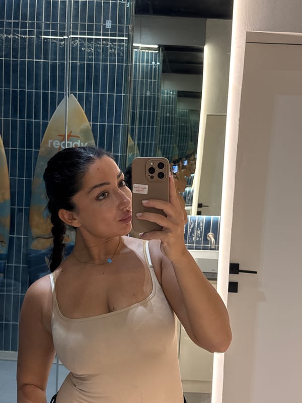 Woman takes bathroom selfie in surf-themed restroom, Kuta Selatan