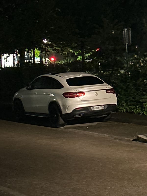 White Mercedes parked on Strasbourg street at night