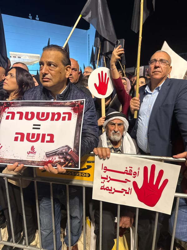 Nighttime protest in Tel Aviv features multilingual signs, civil disobedience