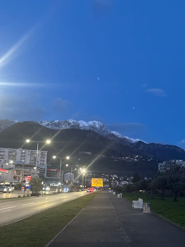 Evening streetlights illuminate commercial district in Bar, Montenegro