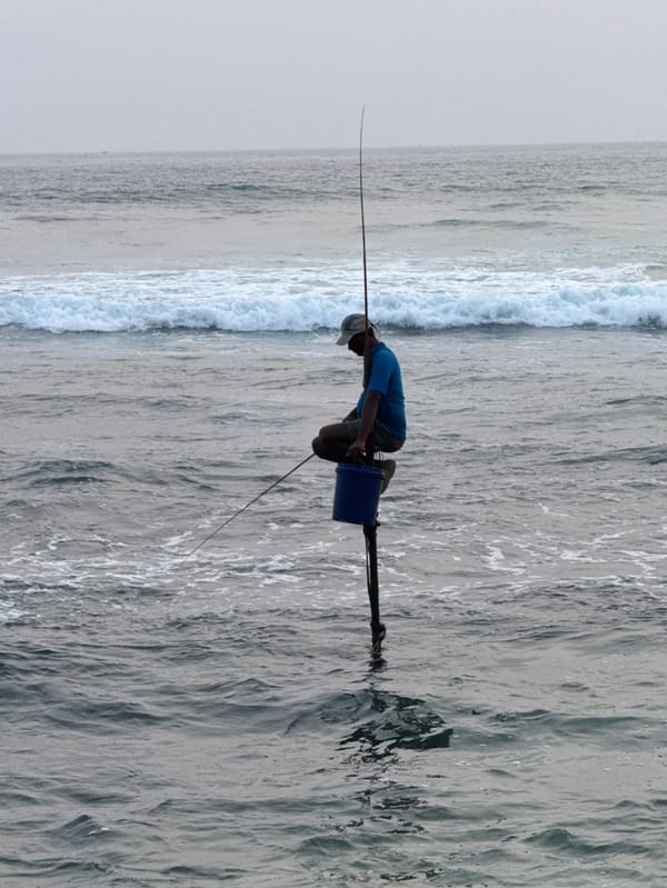 Daily life unfolds along Talpe's coastline with fishermen and beachgoers