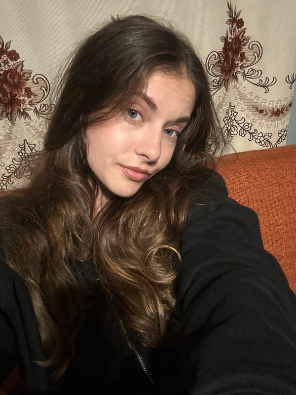 Young woman takes multiple indoor selfies in unknown location