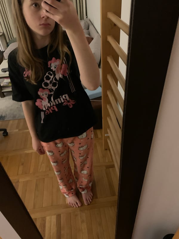 Person takes mirror selfie in pajamas in Belgrade bedroom
