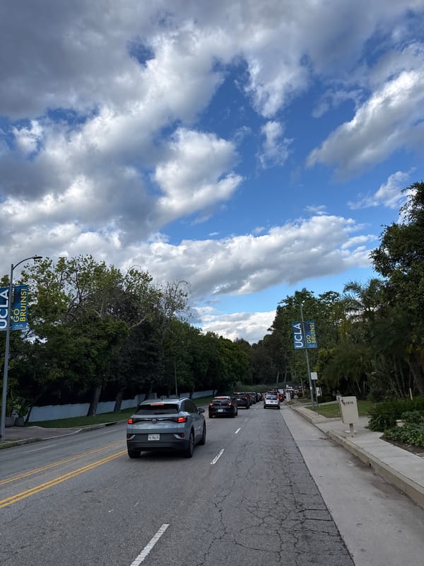 Late-night traffic crawls past UCLA banners in Los Angeles
