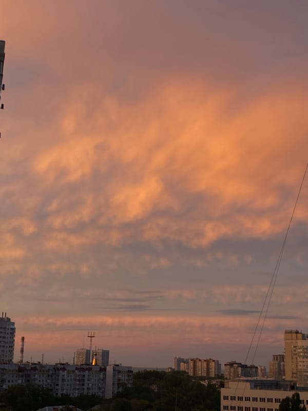 Sunset over high-rise apartments, dramatic sky on full display
