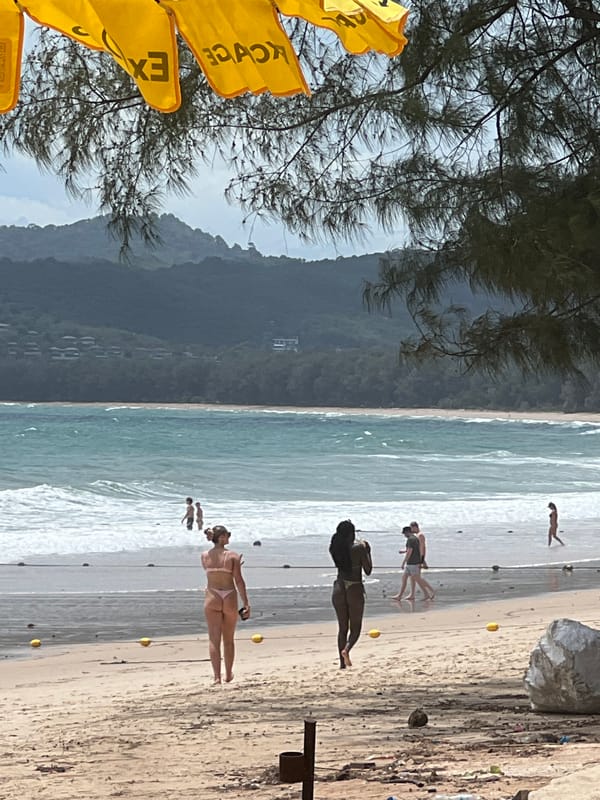Morning beach scenes show tourist area with umbrellas, flags