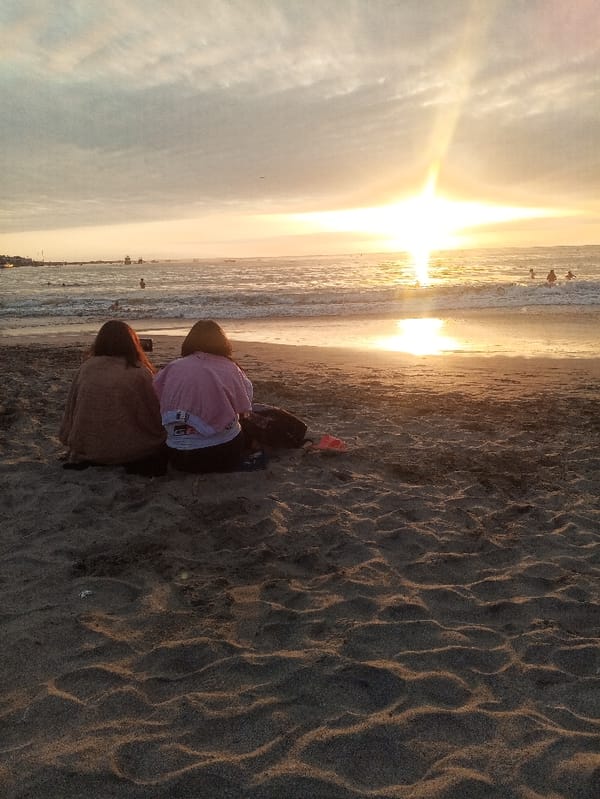 Evening beach gathering observed in Iquique during sunset hours