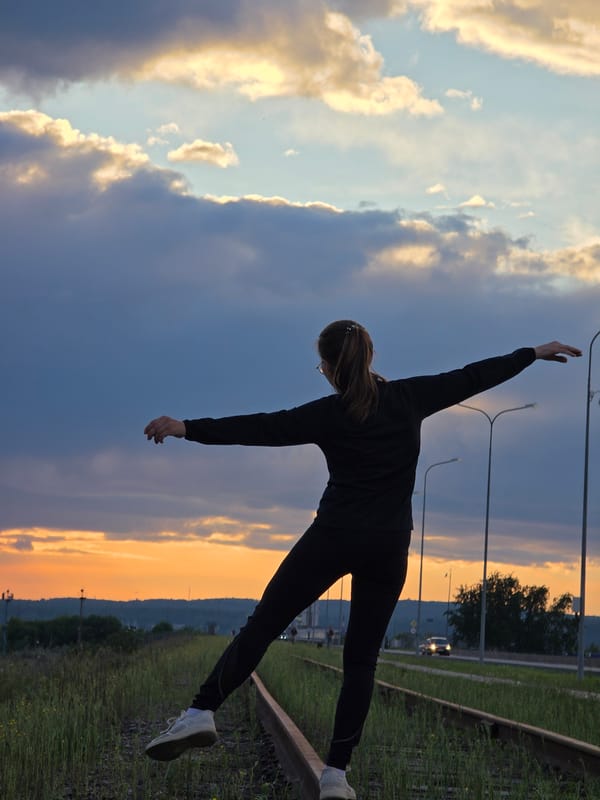 Woman poses for photos on railroad tracks in Chaikovsky