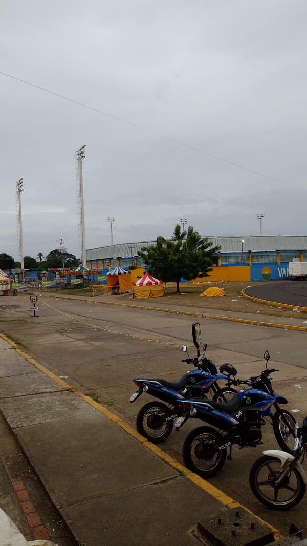 Police motorcycles stationed amid debris in Tinaquillo commercial area