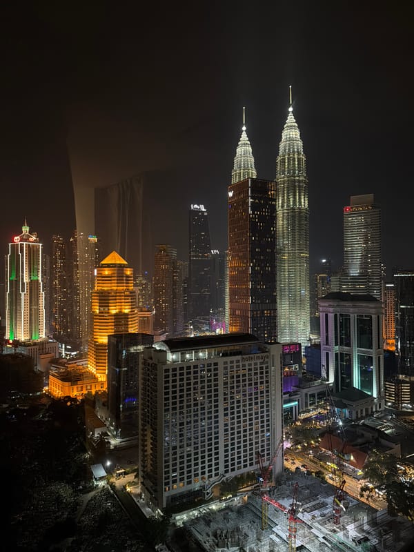 Petronas Twin Towers lit up over Kuala Lumpur at night