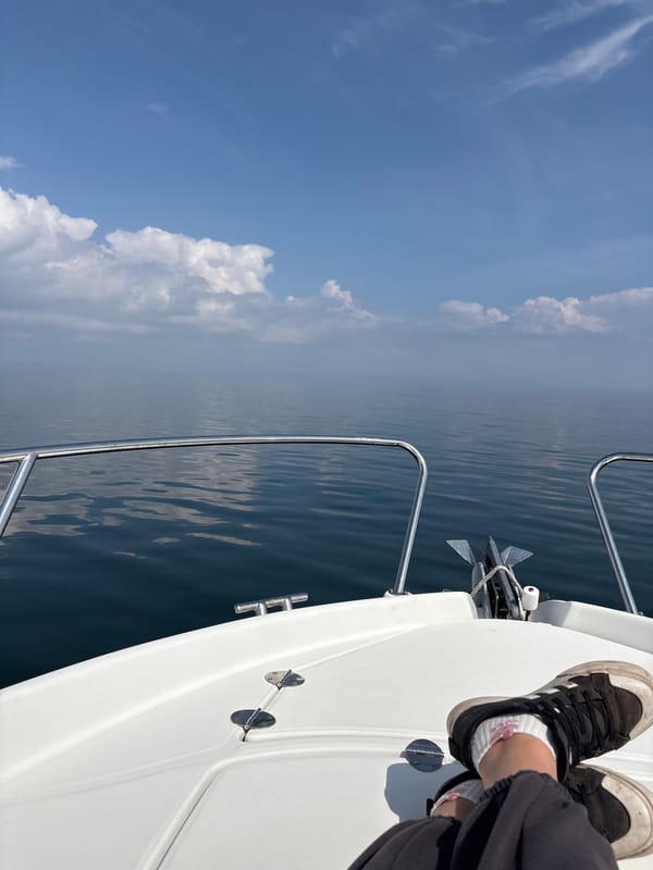 Person sits on boat deck in calm Black Sea waters