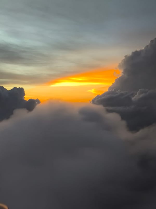 Airplane passenger witnesses sunset above clouds over Sepang, Malaysia