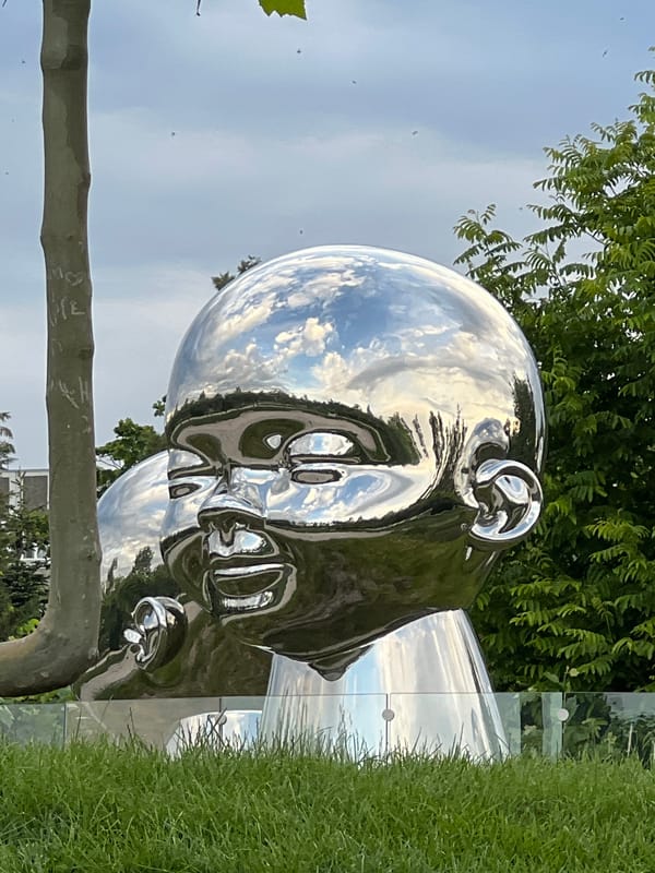 Afternoon park scenes with metallic sculpture documented in Krasnodar