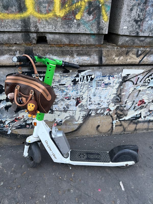 Abandoned e-scooter found on Milan street amid graffiti