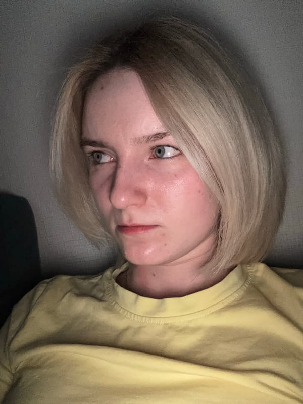 Woman in yellow shirt resting on couch in Vsevolozhsk