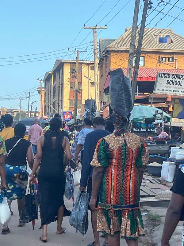 Afternoon foot traffic through a busy Nkpor market street