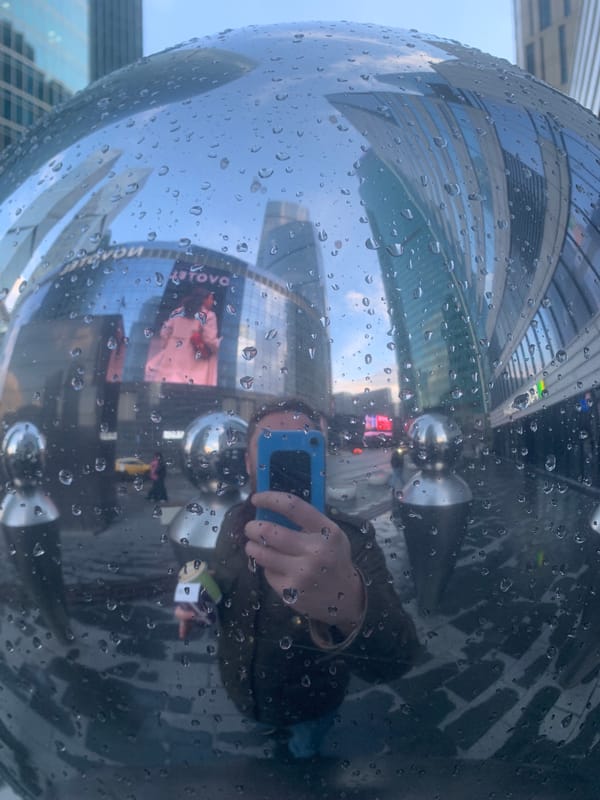 Rain-covered art sphere reflects urban skyline in Khimki
