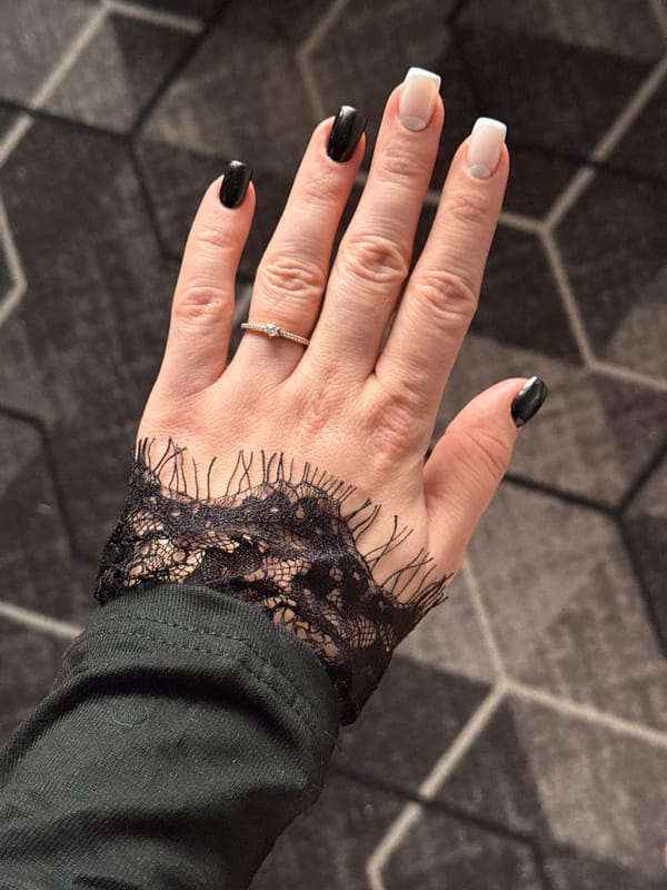 Woman shows manicured nails and diamond ring in Donetsk
