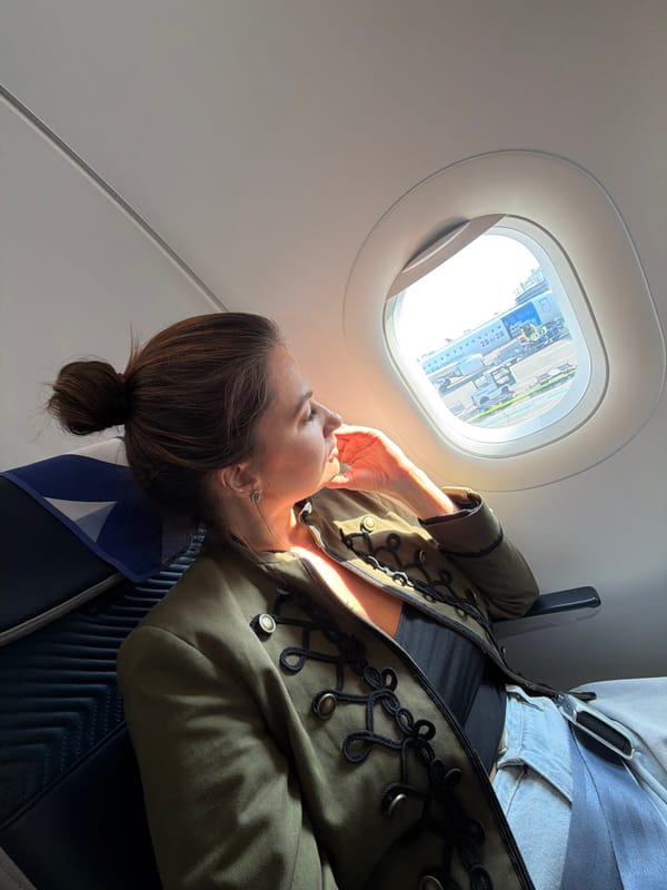 Woman rests aboard aircraft during Belgrade Airport boarding operations