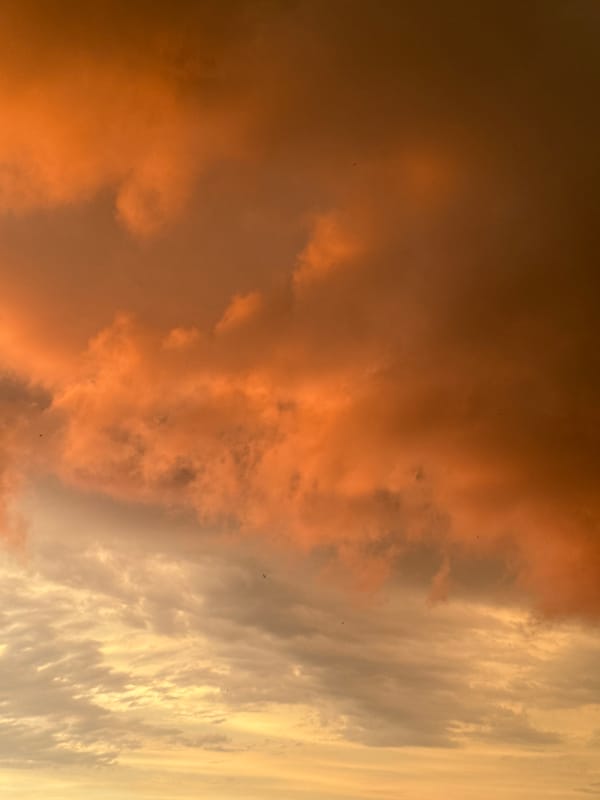 Sunset clouds in warm orange and gray tones