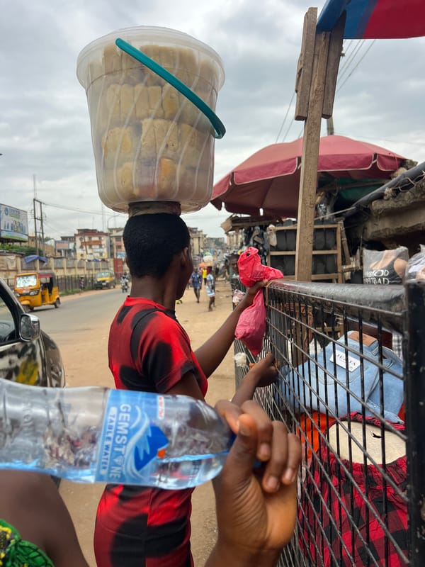 Midday street life and market activity in Nkpor, Nigeria
