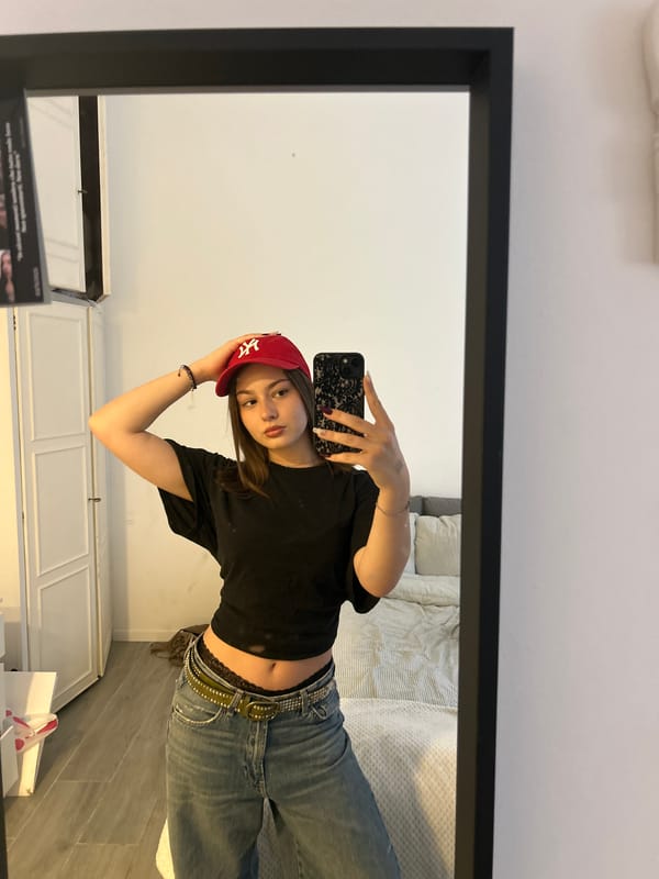 Woman takes mirror selfie in Milan wearing casual outfit