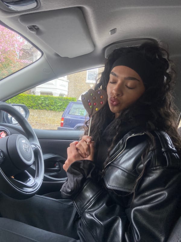 London street moments: chocolate lollipop, peeling sticker captured