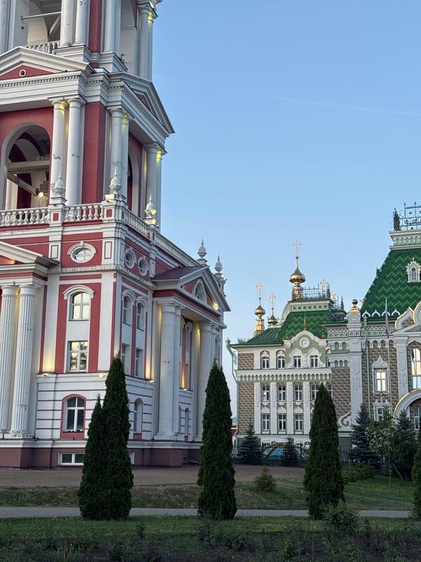 Red-white clock tower with floral displays documented by witnesses
