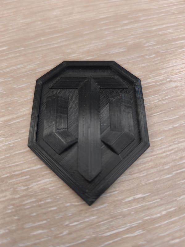3D-printed emblem and a crane-dotted construction site