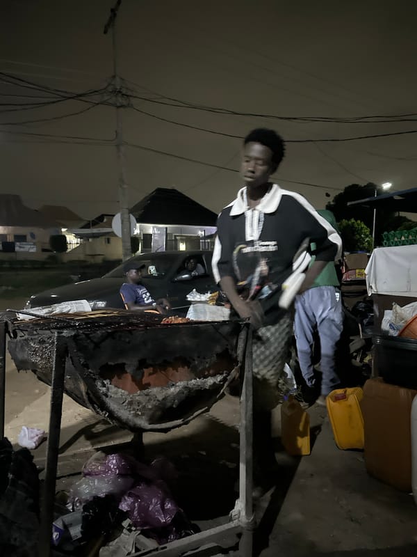 Late-night street food stall in Abuja, grills going strong