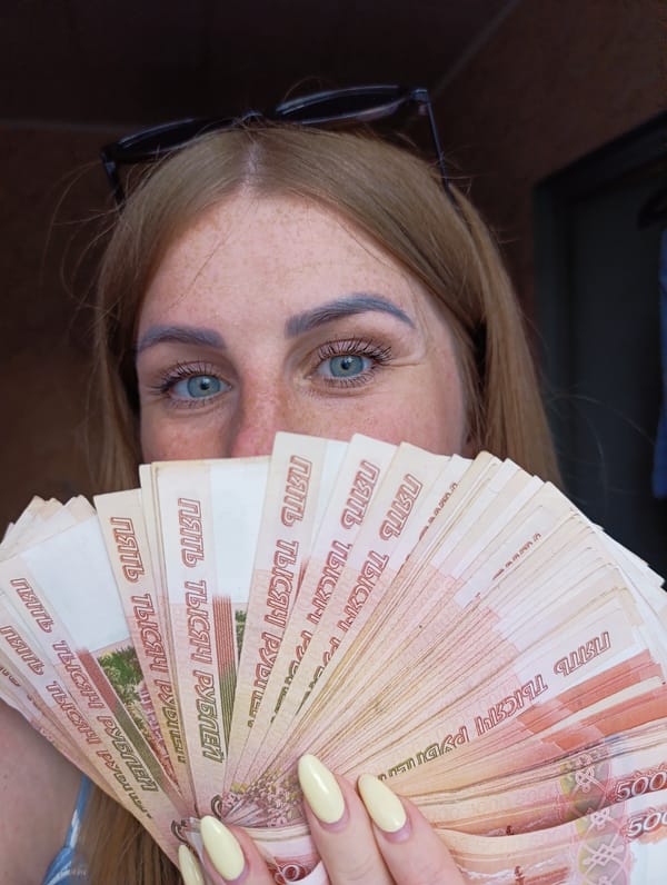 Women display cash, peonies in rural Russian town
