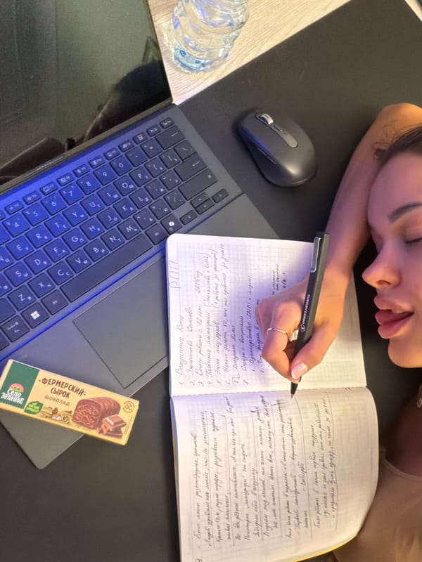 Woman writes in notebook, rests head in quiet Moscow moment