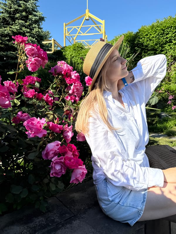 Woman enjoys sunny afternoon among roses in Nebug, Russia