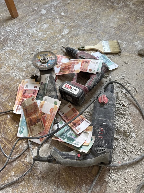 Person poses with cash and construction tools in Russia