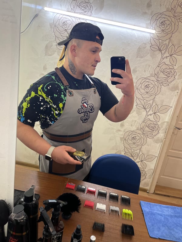Barber takes mirror selfie at shop in Hirevo, Bulgaria