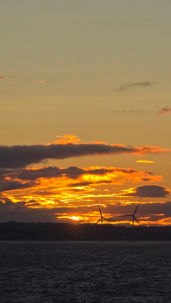 Offshore wind turbines at sunset on the Scottish coast