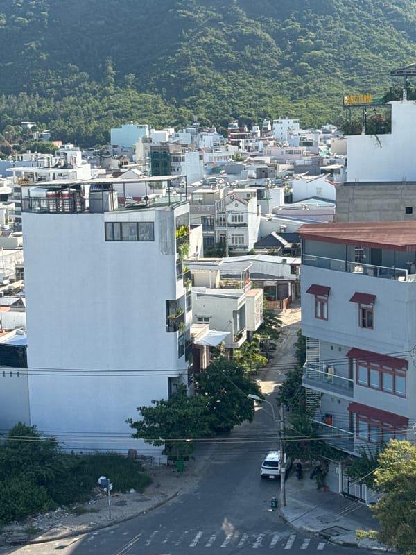 Nha Trang cityscape morning: construction smoke, hills, and street life