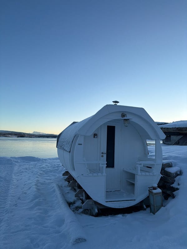 White barrel sauna spotted on snowy waterfront in Harstad