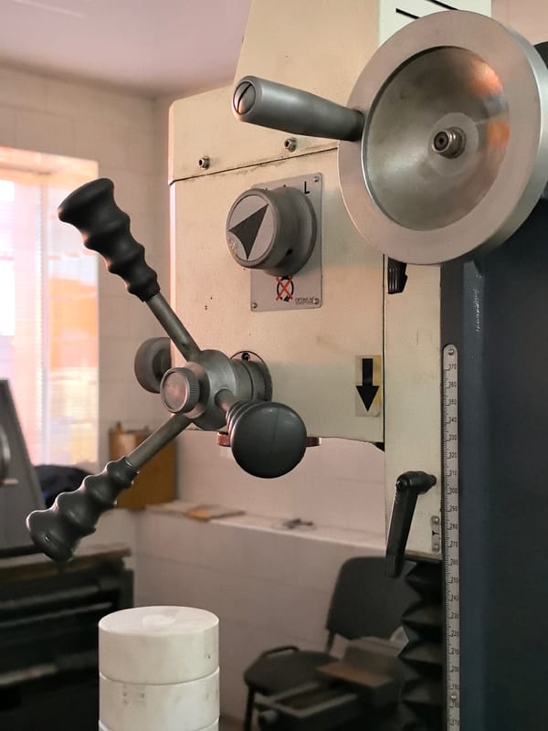 Inside a well-equipped metalworking workshop with industrial machinery