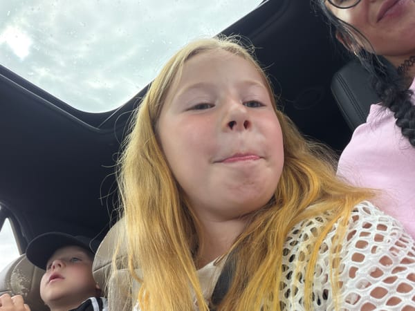 Cloudy day car ride in Шолохово, sunroof open, lollipop in hand