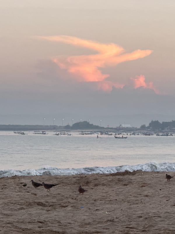 Tourist captures evening beach walk in Kuta, Indonesia