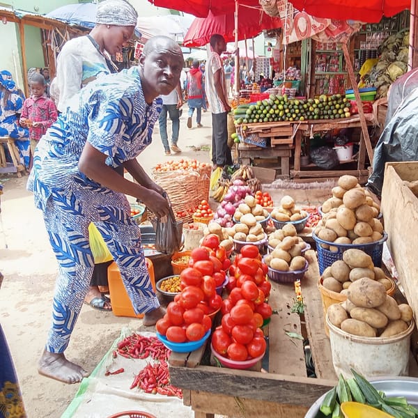 Man shops for tomatoes at bustling Akwanga market