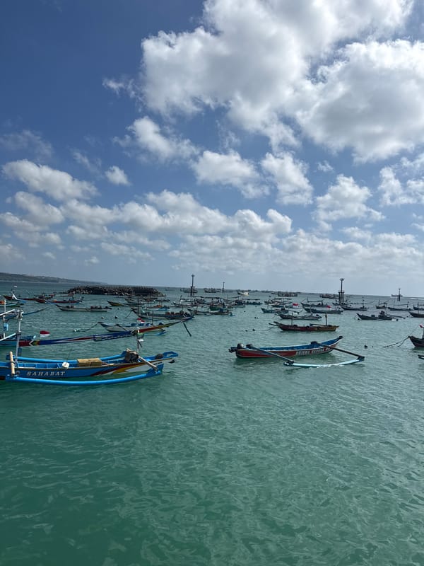 Traditional fishing boats and fresh catch documented in Kuta harbor