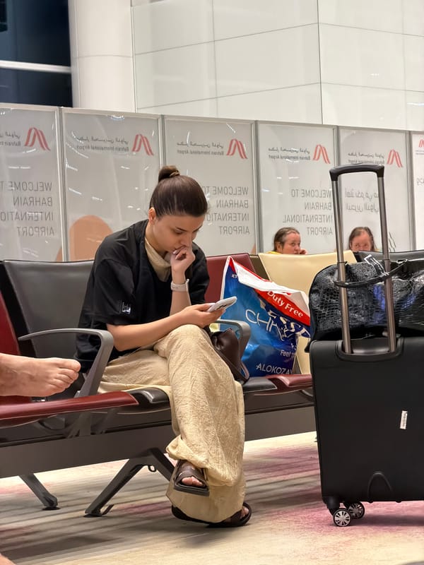 Woman uses phone at Bahrain International Airport terminal