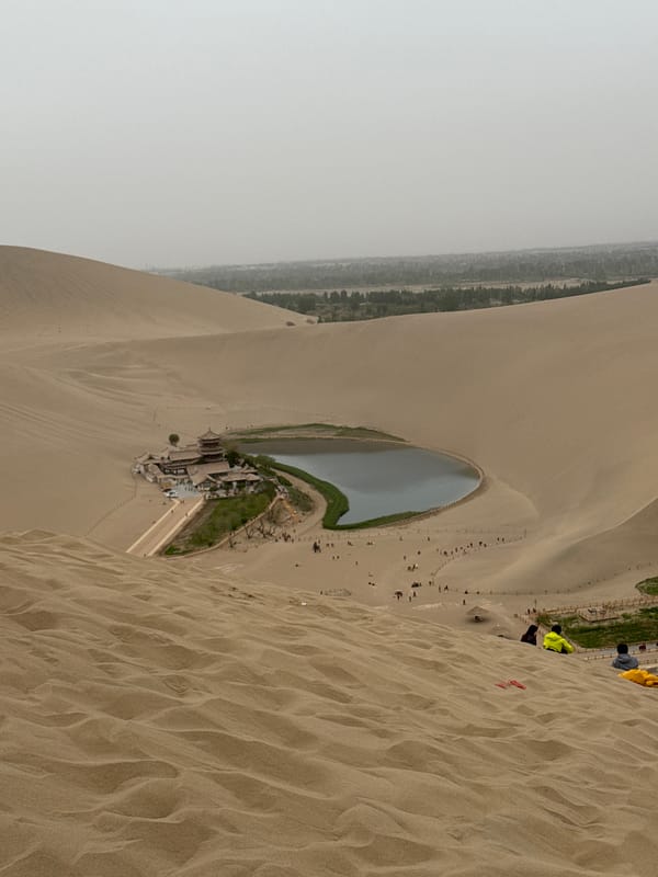 Tourists gather at Crescent Lake desert oasis in Dunhuang