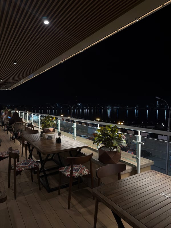 Waterside restaurant observed during evening hours